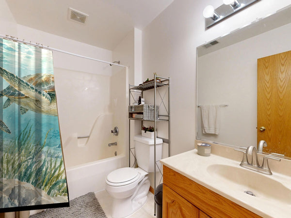 Sea Turtles Ocean shower curtain on a tub shower combo in an American family bathroom