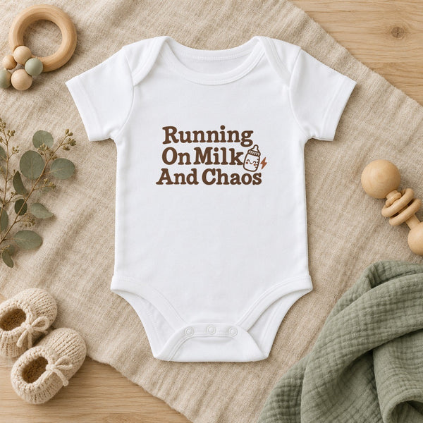Running On Milk And Chaos baby bodysuit in white