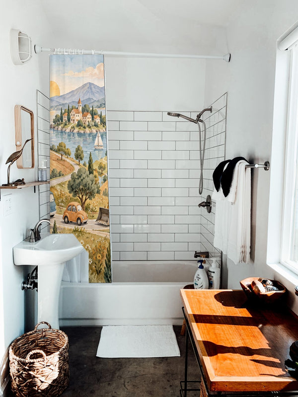Vehicle Parade shower curtain hanging on the rod over a white bathtub