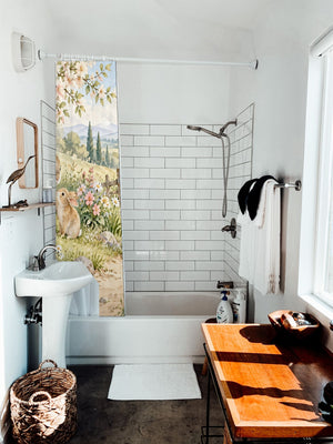 Peaceful Garden Bunny shower curtain hanging on the rod over a white bathtub