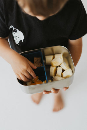 Stainless steel and silicone bento box for babies, perfect for food storage and on-the-go meals. Angle view.
