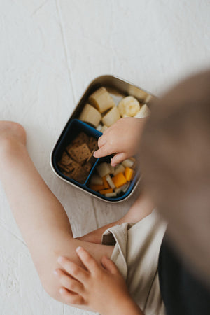 Stainless steel and silicone bento box for babies, perfect for food storage and on-the-go meals.