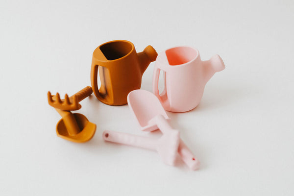 Colorful silicone watering can set for babies, perfect for sand and beach play. Angle 7 view showcasing vibrant design.