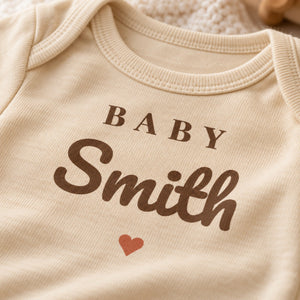 Close-up of the Baby Surname baby bodysuit print