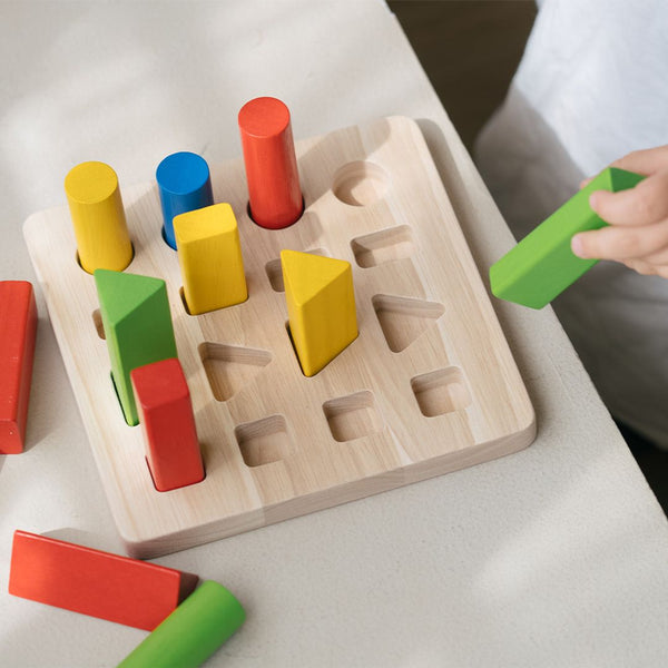 Geometric peg board for babies, promoting early learning and sensory play, viewed from angle 3.