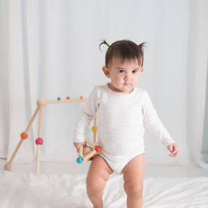 Colorful triangle clutching toy for babies, promoting sensory play and motor skills development. Angle 3 view.