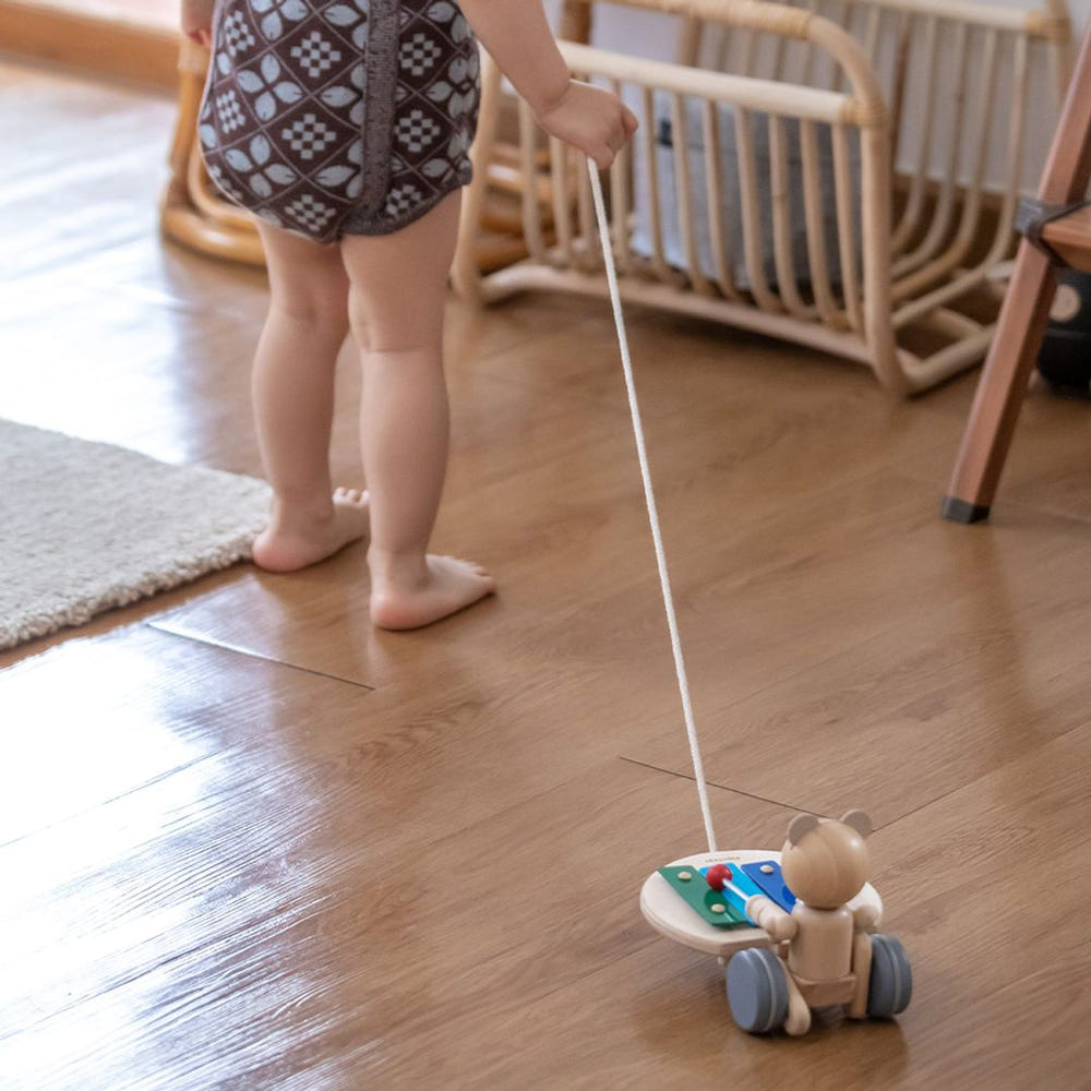 Pull Along Musical Bear toy for babies, featuring a cute design and engaging sounds for entertainment and play.