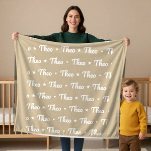 Name Pattern toddler sherpa blanket in oatmeal, held by a mom