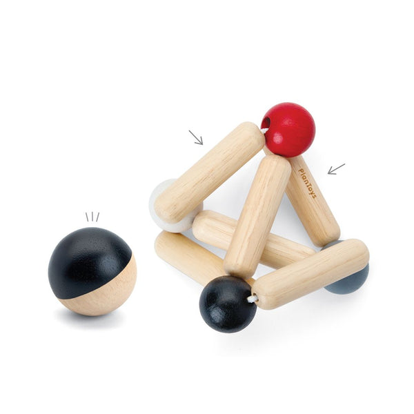 High contrast triangle clutching toy for babies, promoting sensory exploration and fine motor skills. Angle 3 view.