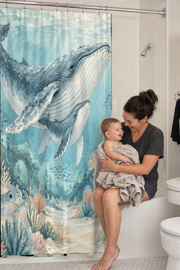 Mom holding her baby on the tub edge next to the Ocean Kingdom shower curtain