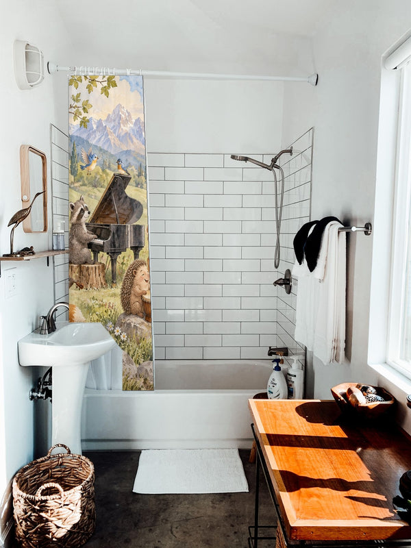 Animal Music Festival shower curtain hanging on the rod over a white bathtub