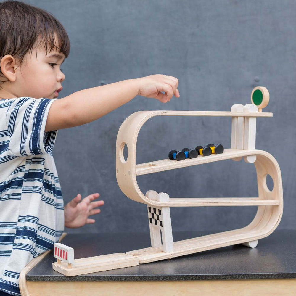 Colorful Ramp Racer toy for babies, featuring multiple tracks for racing cars, promoting fun and motor skills development.