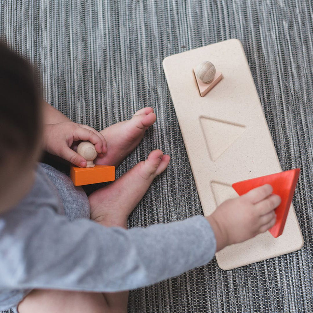 Colorful triangle matching puzzle for babies, promoting early learning and cognitive development through play.