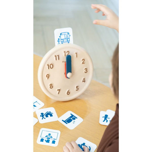 Colorful activity clock for babies, promoting early learning and sensory play, shown from an angled perspective.