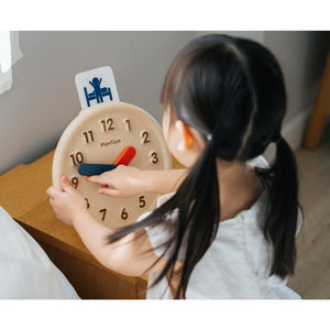 Colorful activity clock for babies, promoting early learning and sensory play, viewed from an angled perspective.
