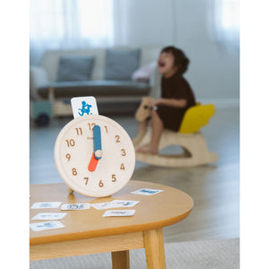 Colorful activity clock for babies, promoting early learning and sensory play, viewed from angle 4.