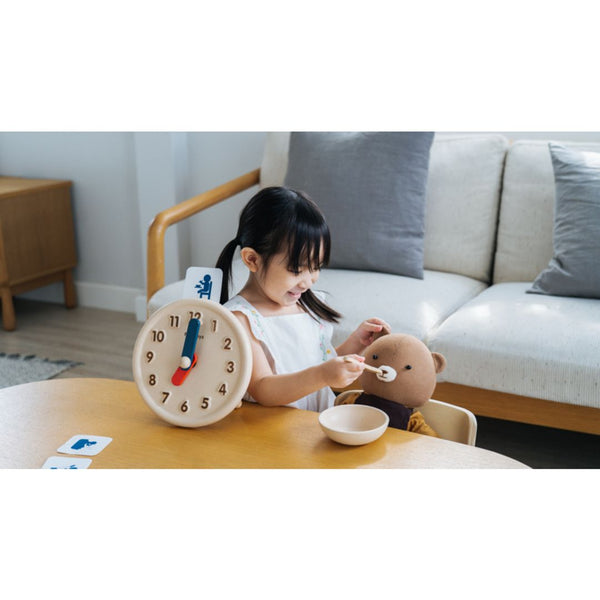 Colorful activity clock for babies, promoting early learning and sensory play, shown from angle 5.