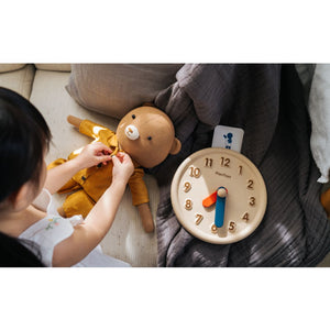 Colorful activity clock for babies, promoting early learning and sensory play, shown from angle 6.