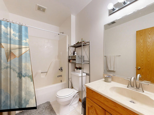 Paper Planes shower curtain on a tub shower combo in an American family bathroom
