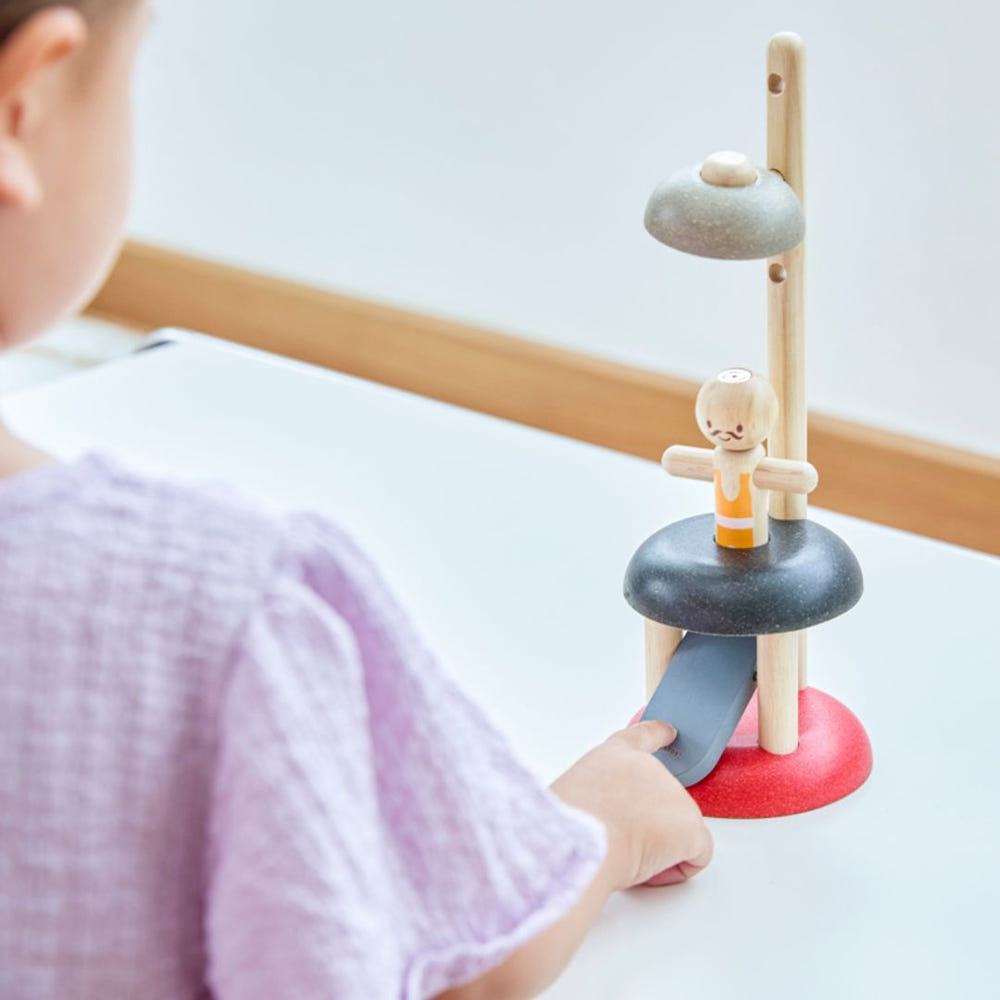 "Jumping Acrobat early learning toy for sensory play, featuring vibrant colors and engaging design for babies."
