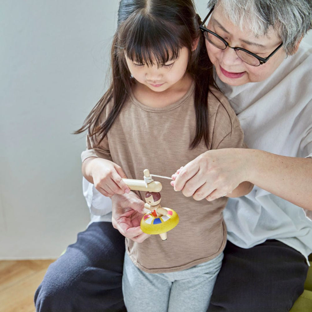 Ballet Spinning Top for babies, promoting early learning and sensory play with vibrant colors and engaging design.