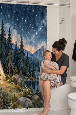 Mom holding her baby on the tub edge next to the Starry Tent Camping shower curtain