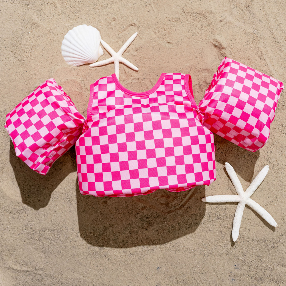Pink checkered kids float for safe and fun water play in pools or at the beach. Perfect for toddlers and young children.
