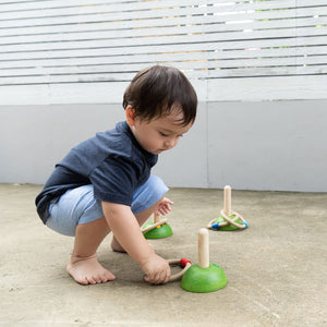 Meadow Ring Toss toy for babies, colorful rings and pegs, promoting hand-eye coordination and fun playtime.