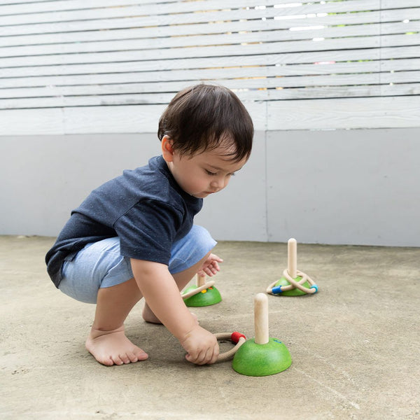 Meadow Ring Toss toy for babies, colorful rings and pegs, promoting hand-eye coordination and fun playtime.