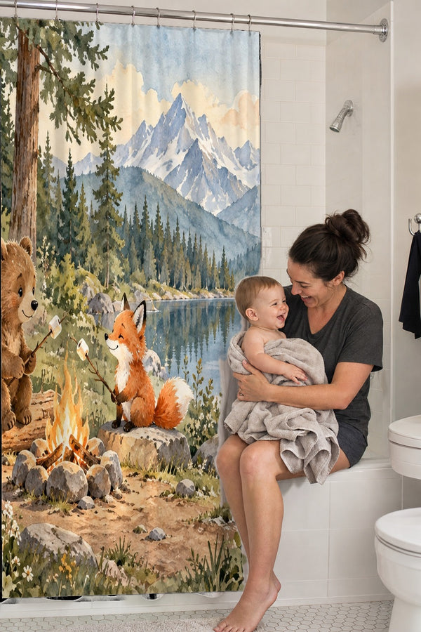 Mom holding her baby on the tub edge next to the Bear and Fox Campfire Camping shower curtain