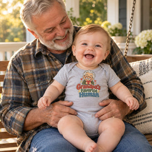 Grandpa holding baby in the Grandpa's Favorite Human baby bodysuit
