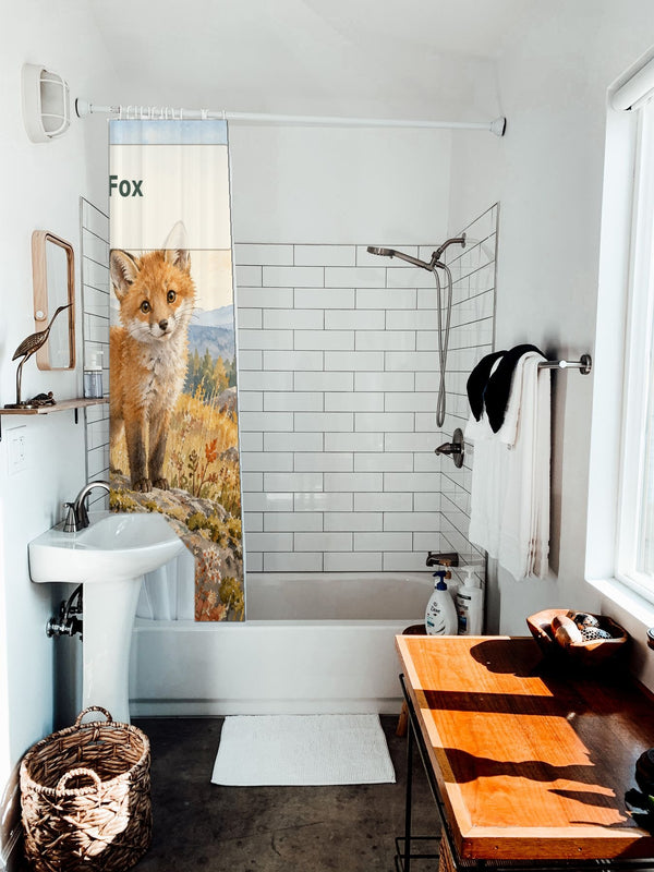 F is for Fox Alphabet shower curtain hanging on the rod over a white bathtub