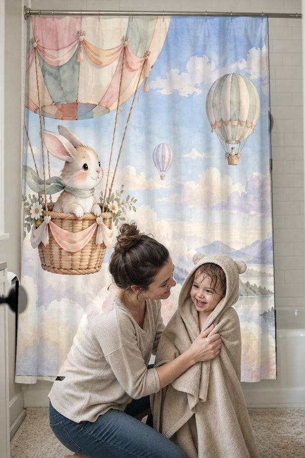 Mom drying her toddler in a hooded towel in front of the Bunny Hot Air Balloon shower curtain