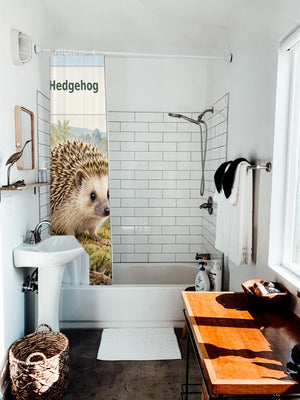 H is for Hedgehog Alphabet shower curtain hanging on the rod over a white bathtub