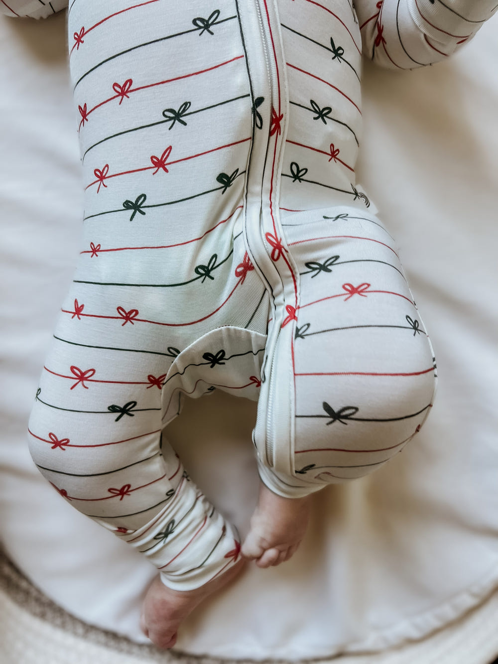Tied with a Bow Christmas Bamboo Zippy Pajamas for babies, festive and cozy holiday sleepwear.
