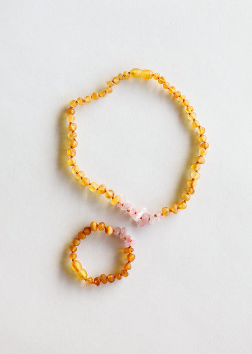 Raw Honey Baltic Amber and Raw Rose Quartz kids necklace set for babies, promoting wellness and style.