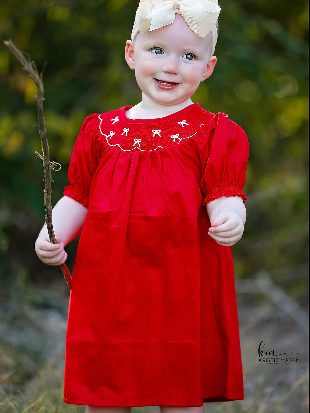 Girls red dress with bow smocking and embroidery, perfect for special occasions.
