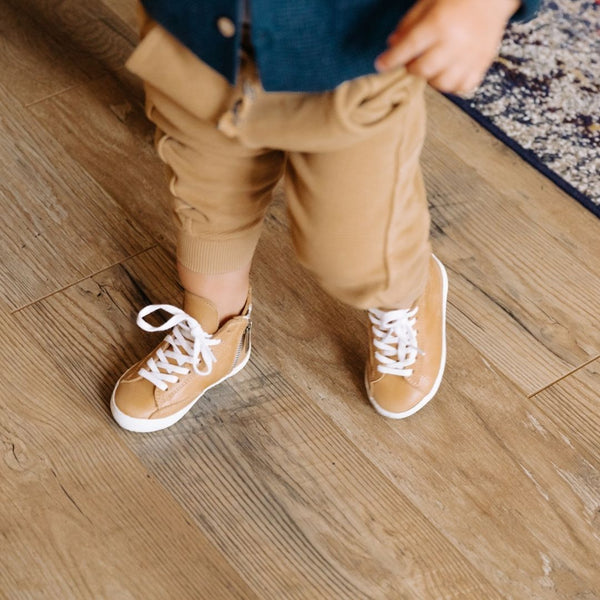 Natural high top sneakers for babies, showcasing a stylish design from angle 2. Perfect for little feet!