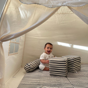 Bold stripe organic cotton play mat for babies, angled view showcasing vibrant colors and soft texture.