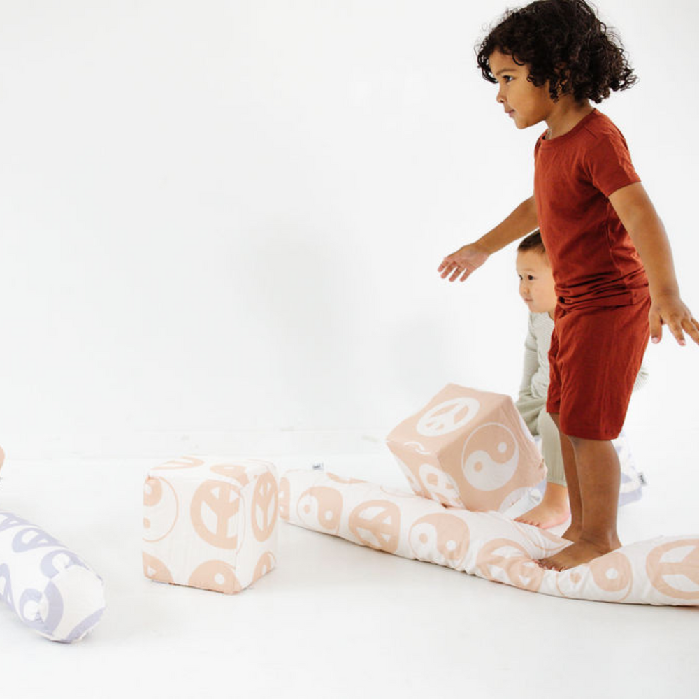 Beige Yin Yang Play Cube for babies, featuring engaging textures and shapes for sensory play and development.