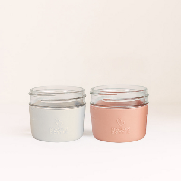 Silicone sleeve cups, 2 pack, angled view, perfect for baby drinkware and easy grip for little hands.