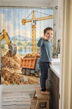 Child brushing teeth in a family bathroom with the Construction Site shower curtain