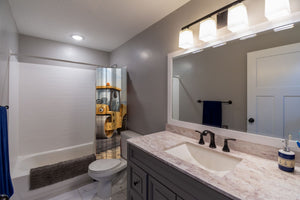 Road Roller shower curtain pulled open in a gray kids bathroom