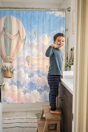 Child brushing teeth in a family bathroom with the Dreamy Clouds Hot Air Balloon shower curtain