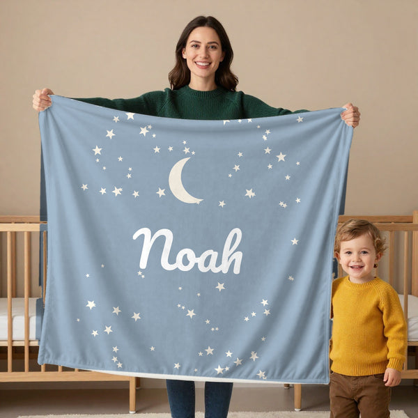 Moon and Stars toddler sherpa blanket in dusty blue, held by a mom