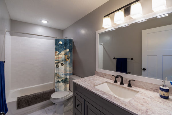Moonlit Flight shower curtain pulled open in a gray kids bathroom