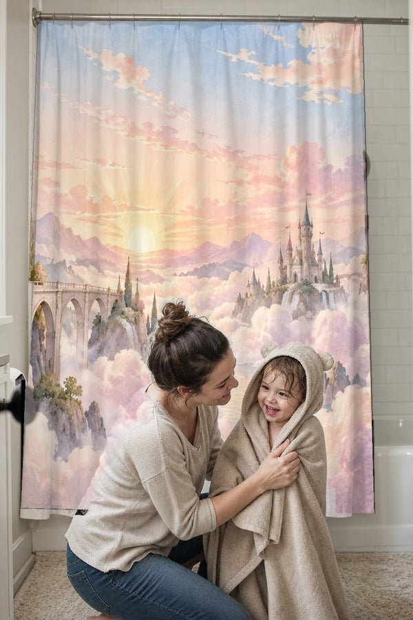 Mom drying her toddler in a hooded towel in front of the Cloud Towers Fairy Tale shower curtain