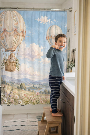 Child brushing teeth in a family bathroom with the Meadow Hot Air Balloons shower curtain