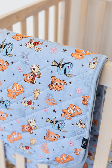 Quilted baby blanket from Lost & Found, perfect for cozy bedding and sleep.