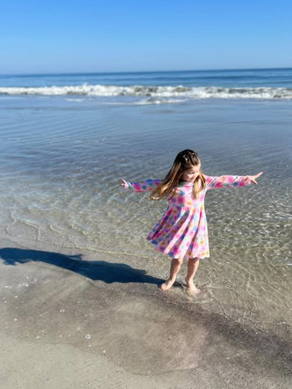Toddler girls' Valentine dress featuring a colorful candy heart print, perfect for festive occasions.